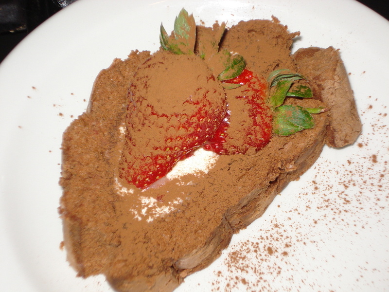 Chocolate and strawberry roule with chocolate ganache and cream