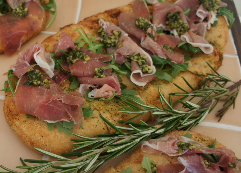 Flatbread topped with Parma ham, wild rocket and pesto